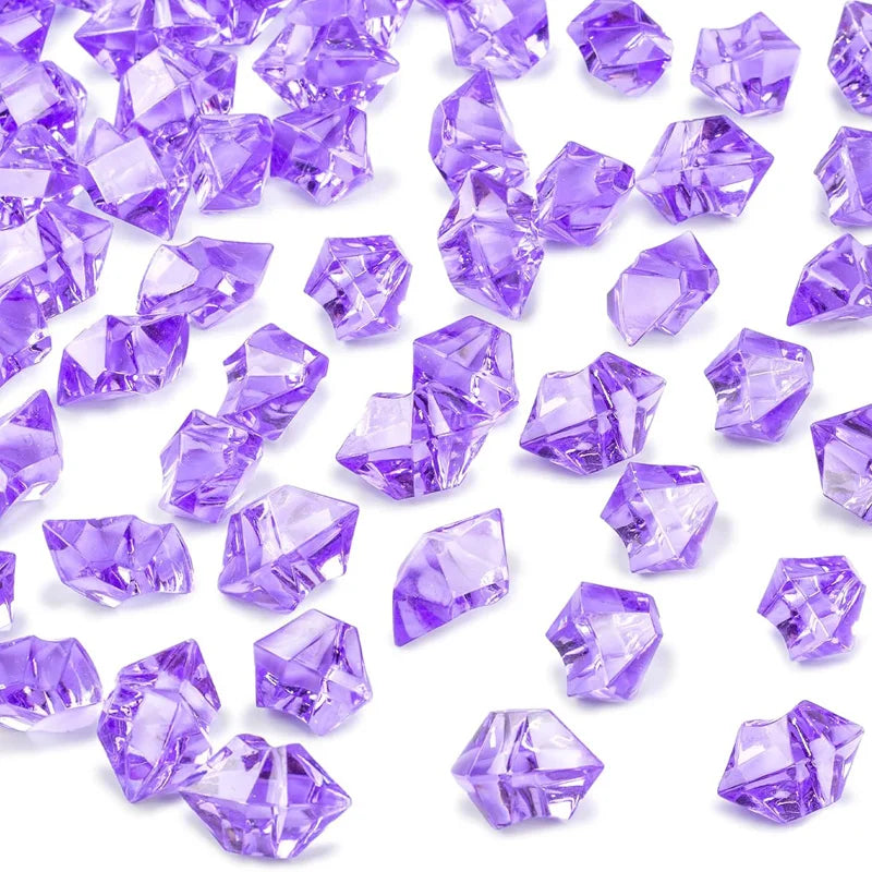 Purple decorative crushed diamond acrylic pebbles scattered on a white background