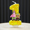 A yellow birthday candle shaped like the number one, decorated with SpongeBob SquarePants characters.