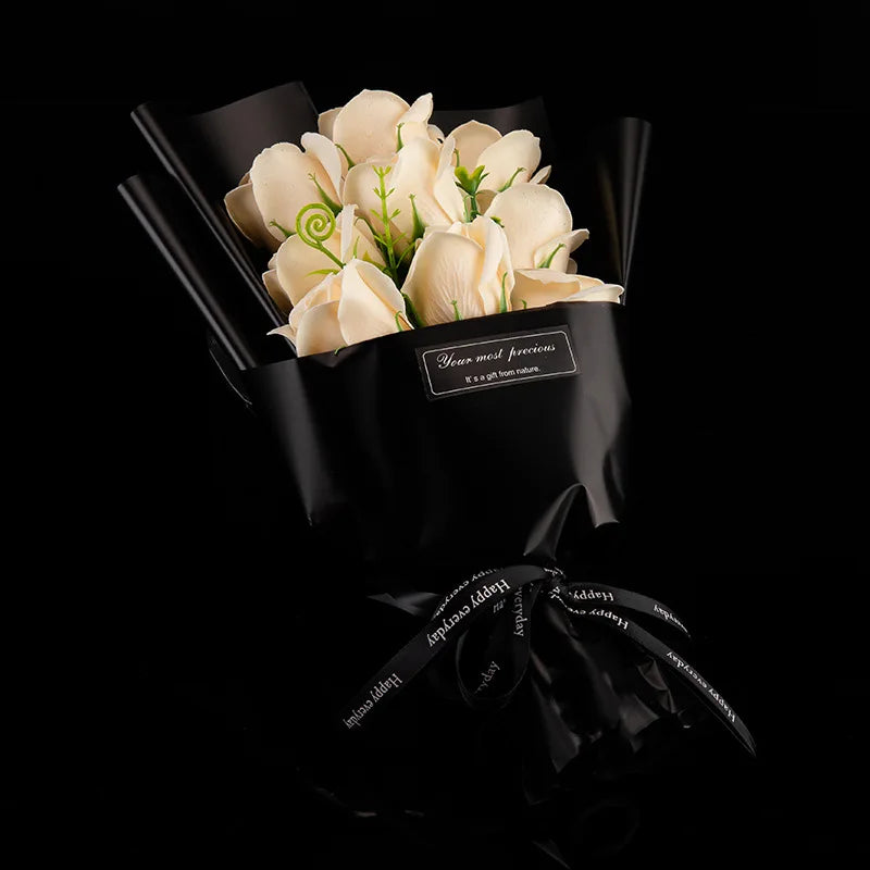A bouquet of handcrafted soap roses wrapped in black paper with a gold ribbon.
