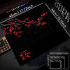 A black gaming mouse pad featuring a red cherry blossom design and various size comparisons.