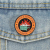 An enamel pin featuring a stylized fire inside a dumpster and the text Dumpster Fire Response Team