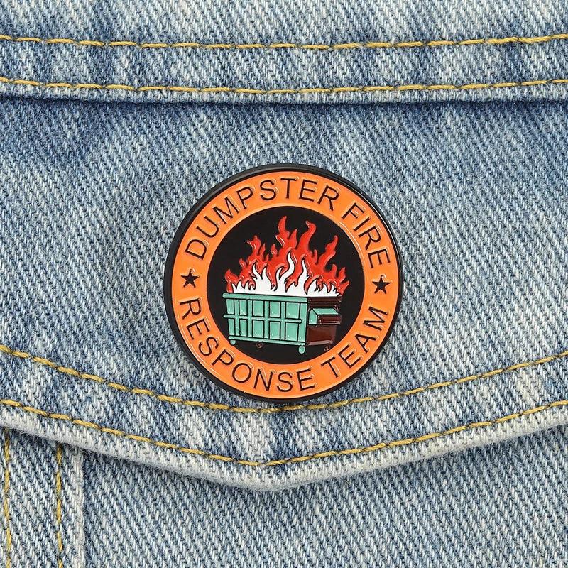 An enamel pin featuring a stylized fire inside a dumpster and the text Dumpster Fire Response Team