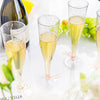 Clear plastic champagne flutes with stem used for serving sparkling wine