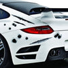 A white sports car features realistic bullet hole decals and a prominent rear spoiler.