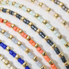A collection of handmade boho glass bead bracelets featuring various colors and gold accents.