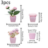 Three small pink faux bonsai plants in various pot sizes and heights for home decor