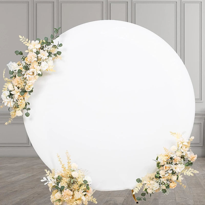 A round white photo backdrop decorated with light yellow and white floral greenery