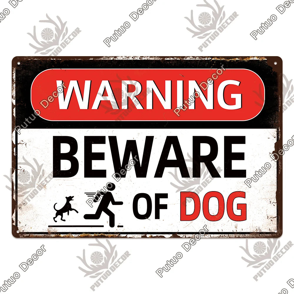 A vintage warning metal sign with a red top and white body that reads WARNING BEWARE OF DOG