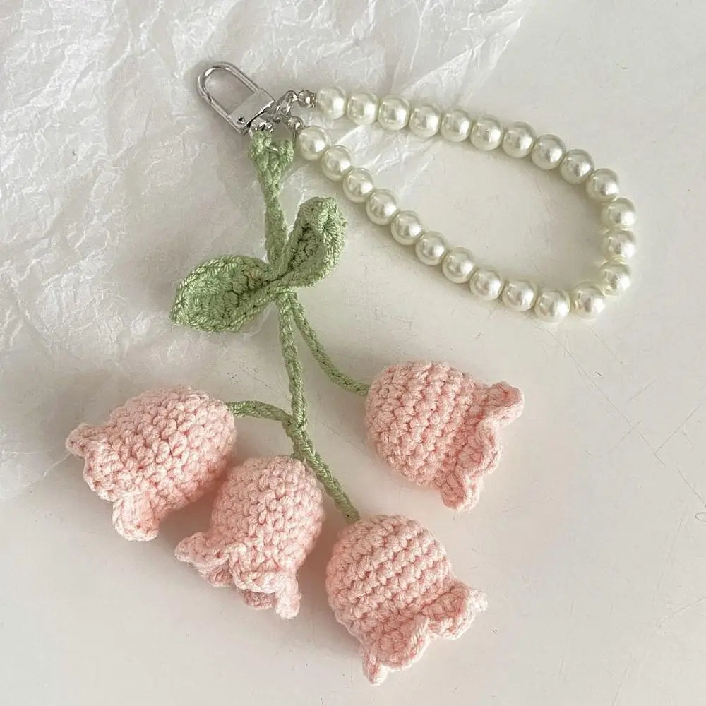 Handmade pearl chain orchid key ring with a light pink crocheted flower and green stem