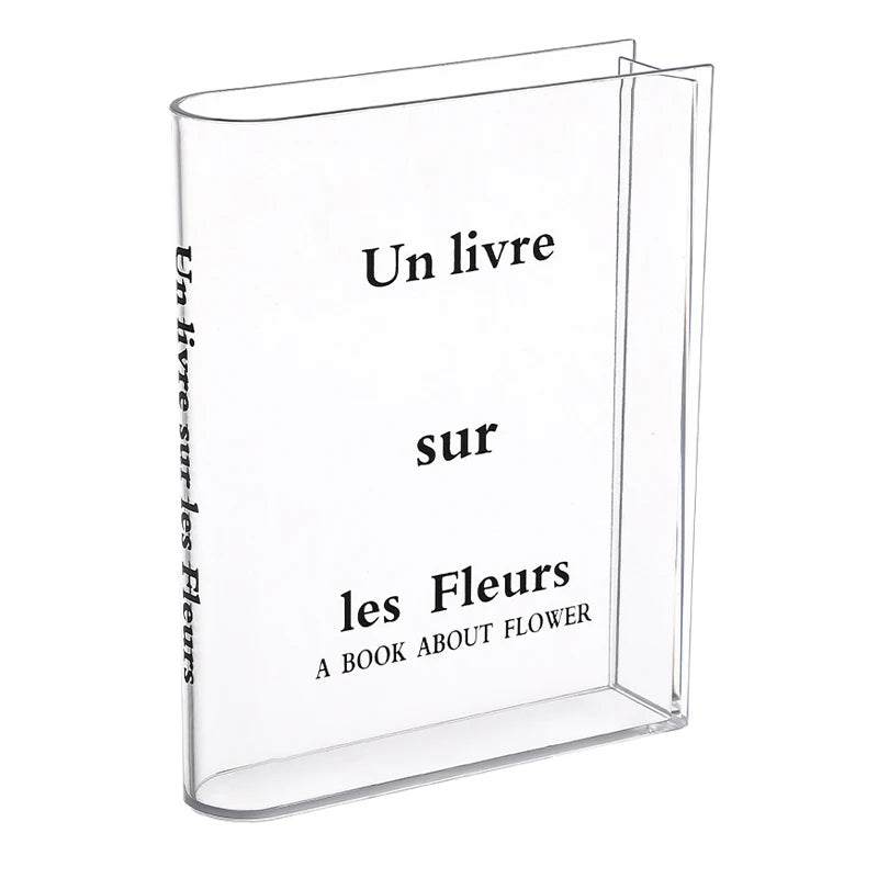 Clear acrylic book vase with flower holder displaying the title Un livre sur les Fleurs