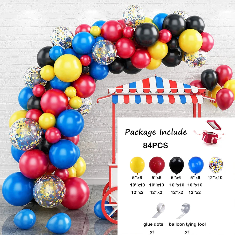 A balloon garland arch kit featuring various colored balloons and star foil accents displayed against a white brick wall.