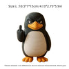 A black and white penguin desk statue with one flipper raised in a thumbs-up gesture.