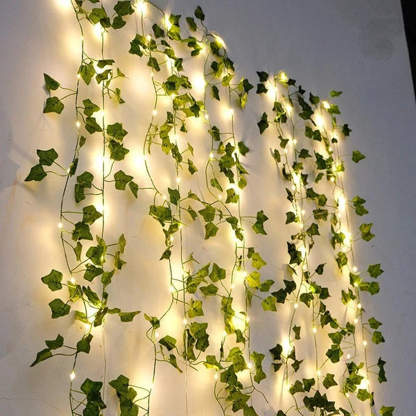 Green leaf string lights with ivy vines decorating a surface.