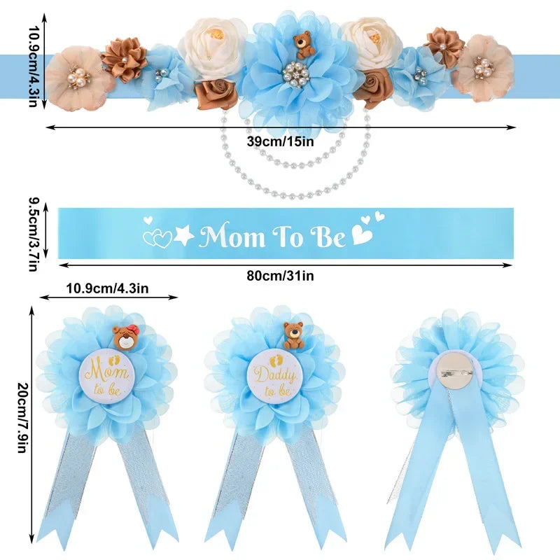 A set of floral maternity sash and corsage pins featuring light blue flowers and accents for a baby shower.