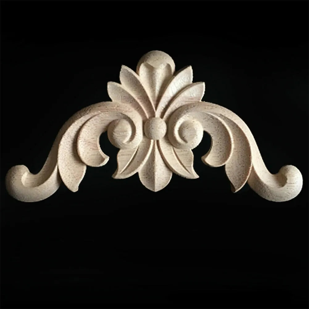 A light-colored wooden carved corner applique with a decorative floral design.