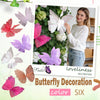 A woman holds a white butterfly decoration against a green foliage background for butterfly decor.