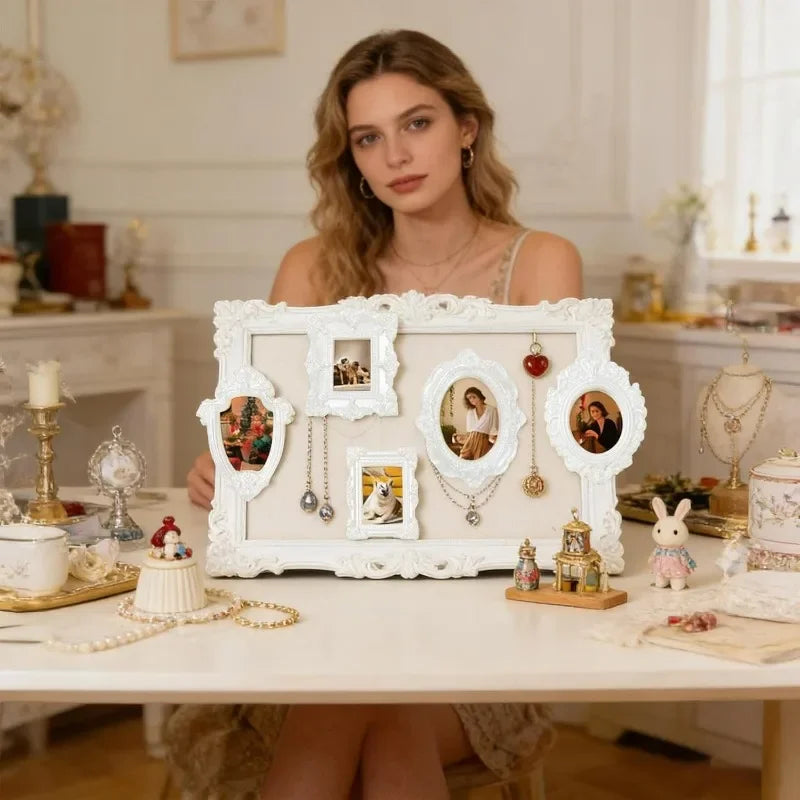 A woman sits at a table surrounded by vintage resin picture frames and craft supplies.