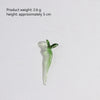 A small, translucent green glass flower with a stem, used for home decor.