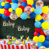 A vibrant balloon garland arch featuring rainbow colors and star foil accents for a party decoration.