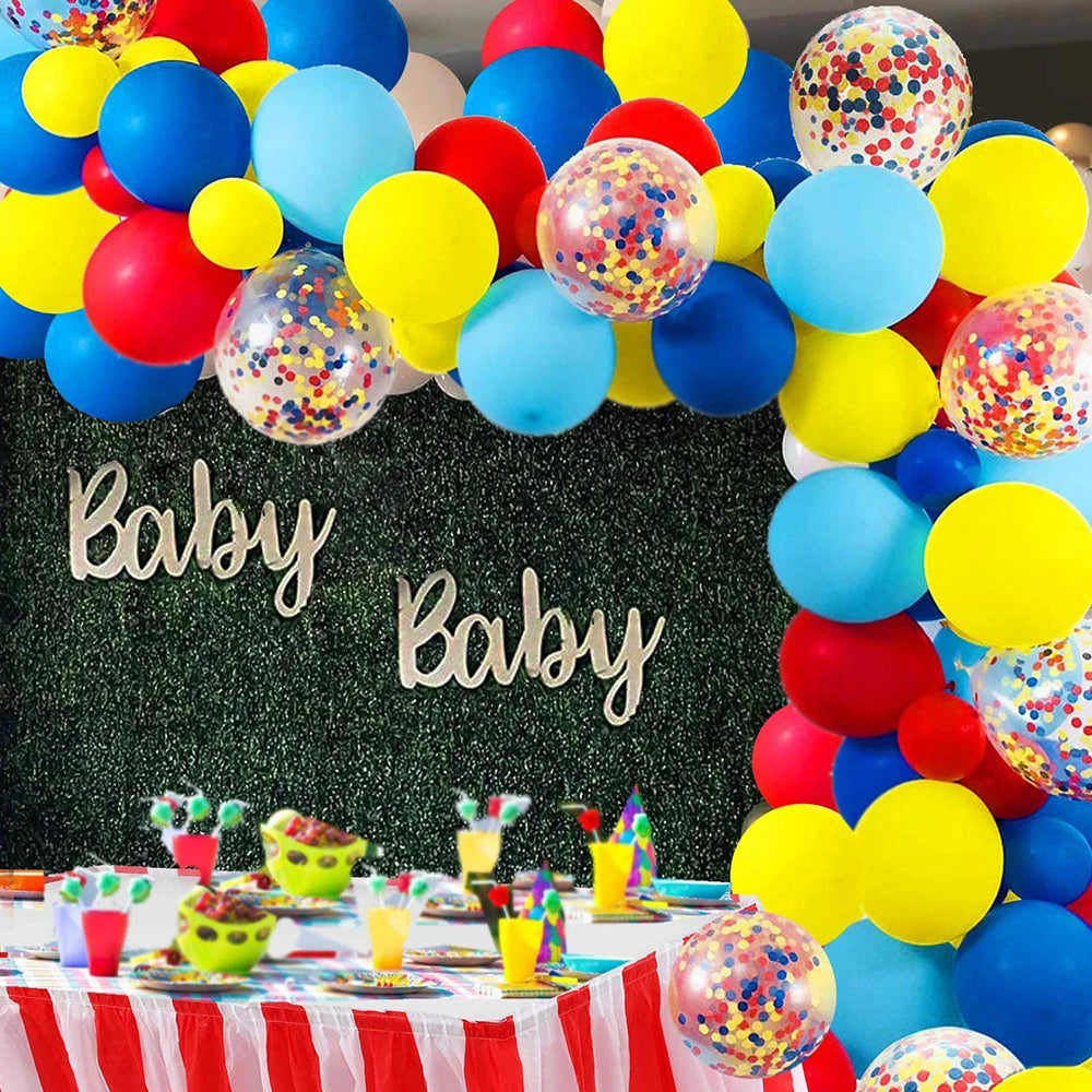 A vibrant balloon garland arch featuring rainbow colors and star foil accents for a party decoration.