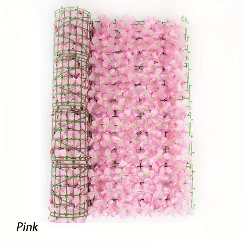 A vertical roll of pink artificial cherry blossom privacy fence screen.