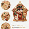 A detailed gingerbread house ornament kit featuring pearl and drill accents with an intricate holiday pattern.
