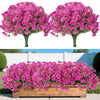 Two clusters of vibrant pink artificial silk flowers displayed against a white fence and green foliage.