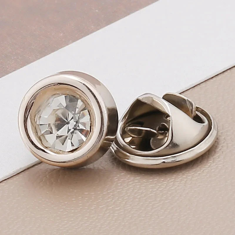Silver rhinestone buttons with a pearl center are shown on a light background.