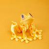 A yellow, three-dimensional printed tree frog ornament is displayed against a solid orange background.