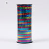 A cylindrical roll of glitter curling ribbon featuring horizontal stripes in various bright colors.