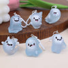 A set of light blue glow-in-the-dark ghost keychains shaped like cute, smiling ghosts.