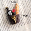 A set of three 3D fruit fridge magnets featuring a banana, avocado, and a slice of orange on a woven basket.