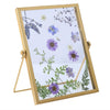 A modern metal and acrylic photo frame with a gold finish displaying delicate purple and blue floral illustrations.