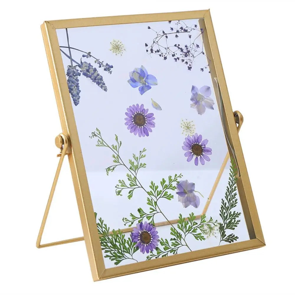 A modern metal and acrylic photo frame with a gold finish displaying delicate purple and blue floral illustrations.