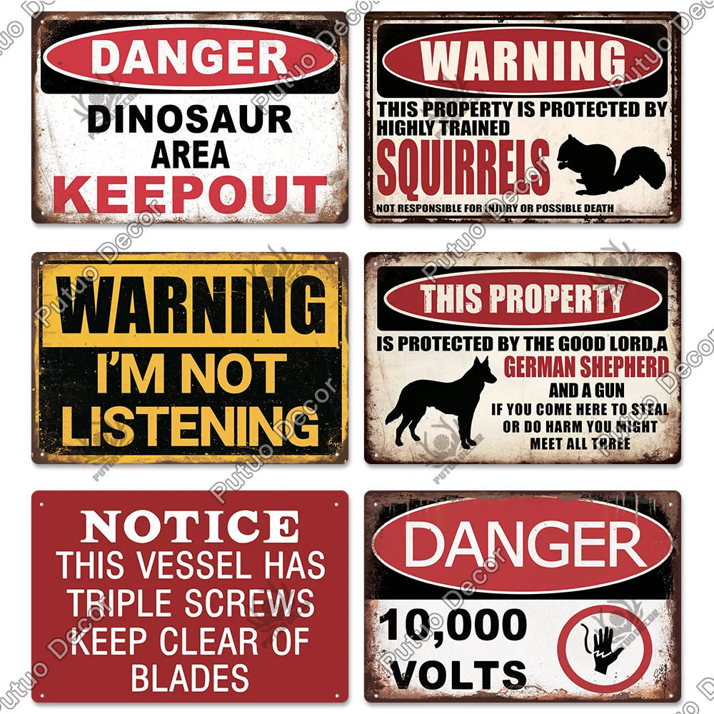 A collection of vintage warning metal signs featuring text like DANGER DINOSAUR AREA KEEPOUT WARNING I'M NOT LISTENING and NO