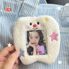 A white plush photo card holder with a smiling face and stars, displaying a picture of a woman.