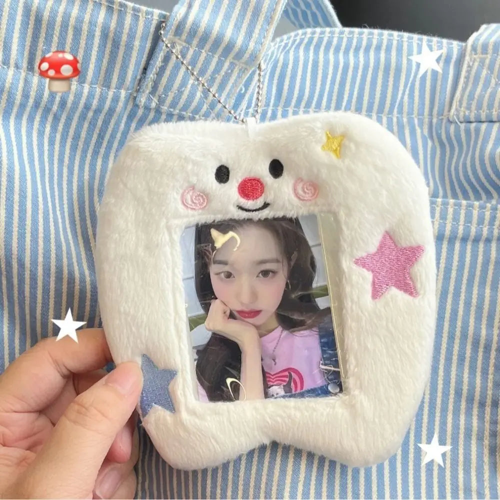 A white plush photo card holder with a smiling face and stars, displaying a picture of a woman.