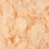 A close-up view of light peach artificial silk rose petals scattered on a surface.