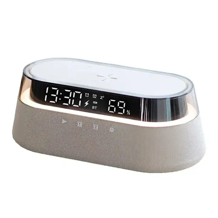 A modern, silver-colored wireless charging speaker lamp with a digital display showing time and battery percentage.