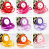 Various rolls of pink silk satin ribbon in different shades and widths displayed on a white background.