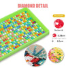 A diamond painting kit featuring colorful beads on a green tray and sample sections of the finished artwork.