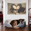 A dark brown dog lies inside a gray fabric bowl on a wooden floor in a bright room.