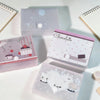 Colección de cajas de almacenamiento minimalistas para pegatinas y tarjetas en varios tonos pastel y diseños.