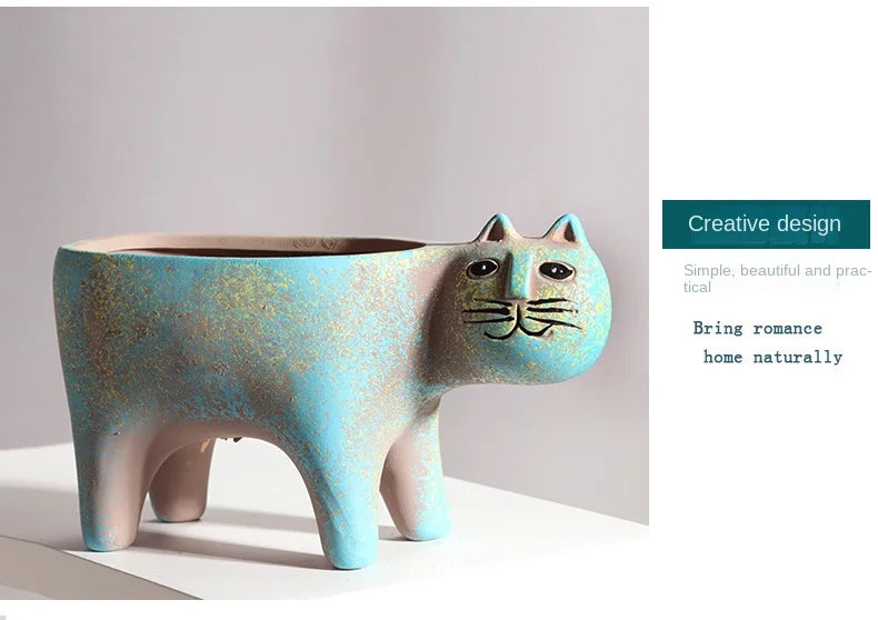 A ceramic succulent planter shaped like a cat, featuring a pale blue body with gold speckles.