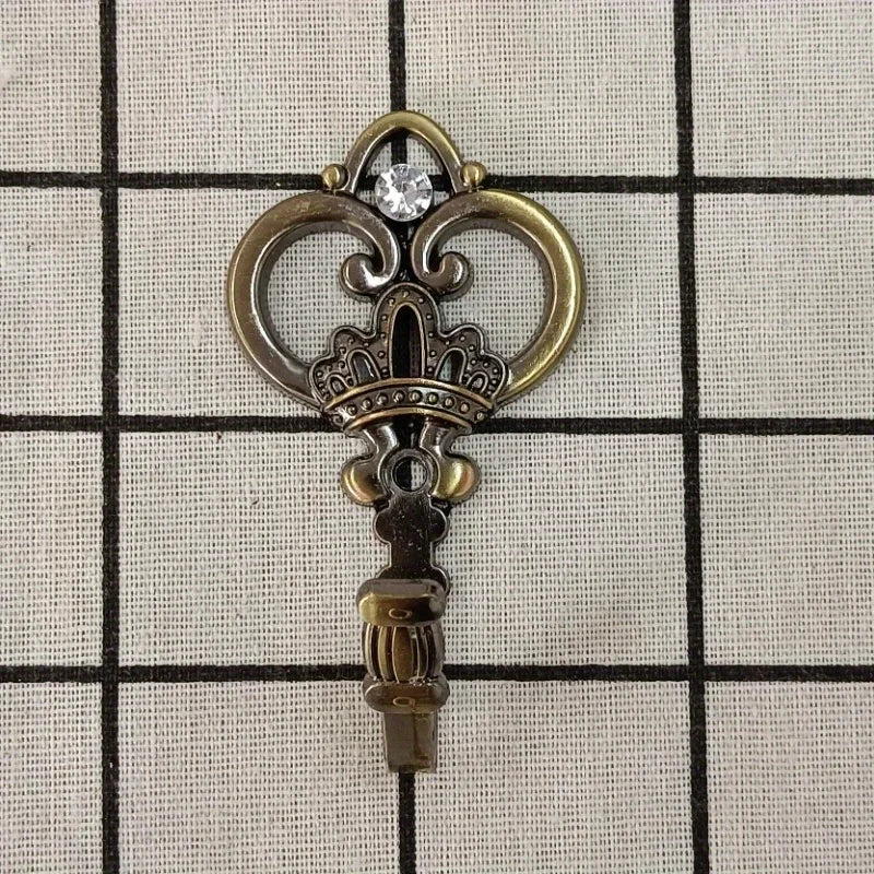 Vintage gold-toned crown curtain hooks with a clear gemstone detail