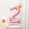 Pink aluminum foil number 2 balloon with a gold crown topper