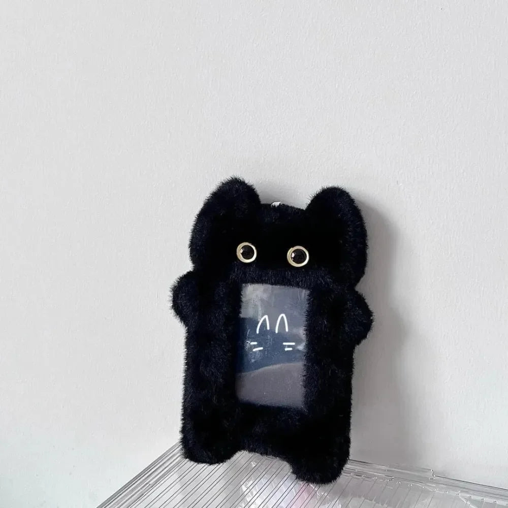 A black plush photocard holder with a zipper closure is displayed against a white background.