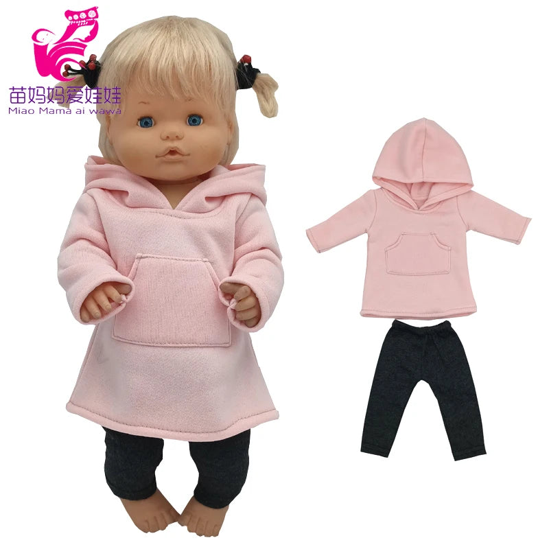 A baby doll wearing a pink hoodie and pants with a matching hat.