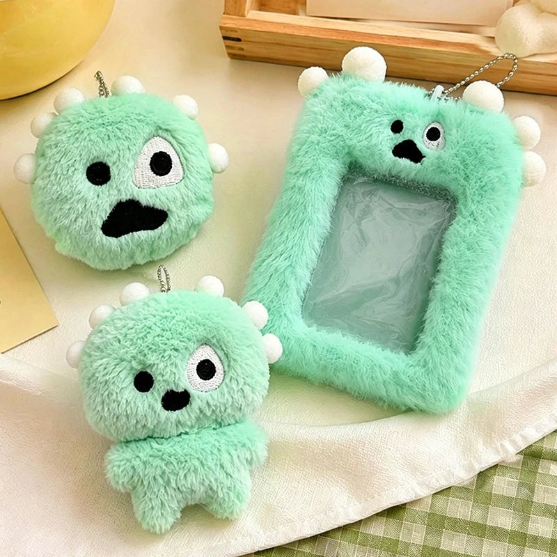 A light green fluffy plush keychain with a clear plastic holder for photos is displayed on a white cloth.
