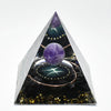 Handmade resin orgonite pyramid featuring natural obsidian and a copper coil inside.